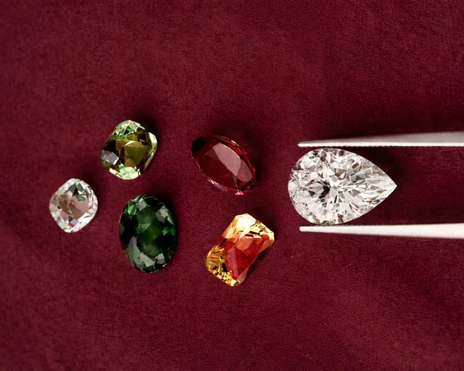 Diamond and gemstones being considered during jewellery repair and stone replacement