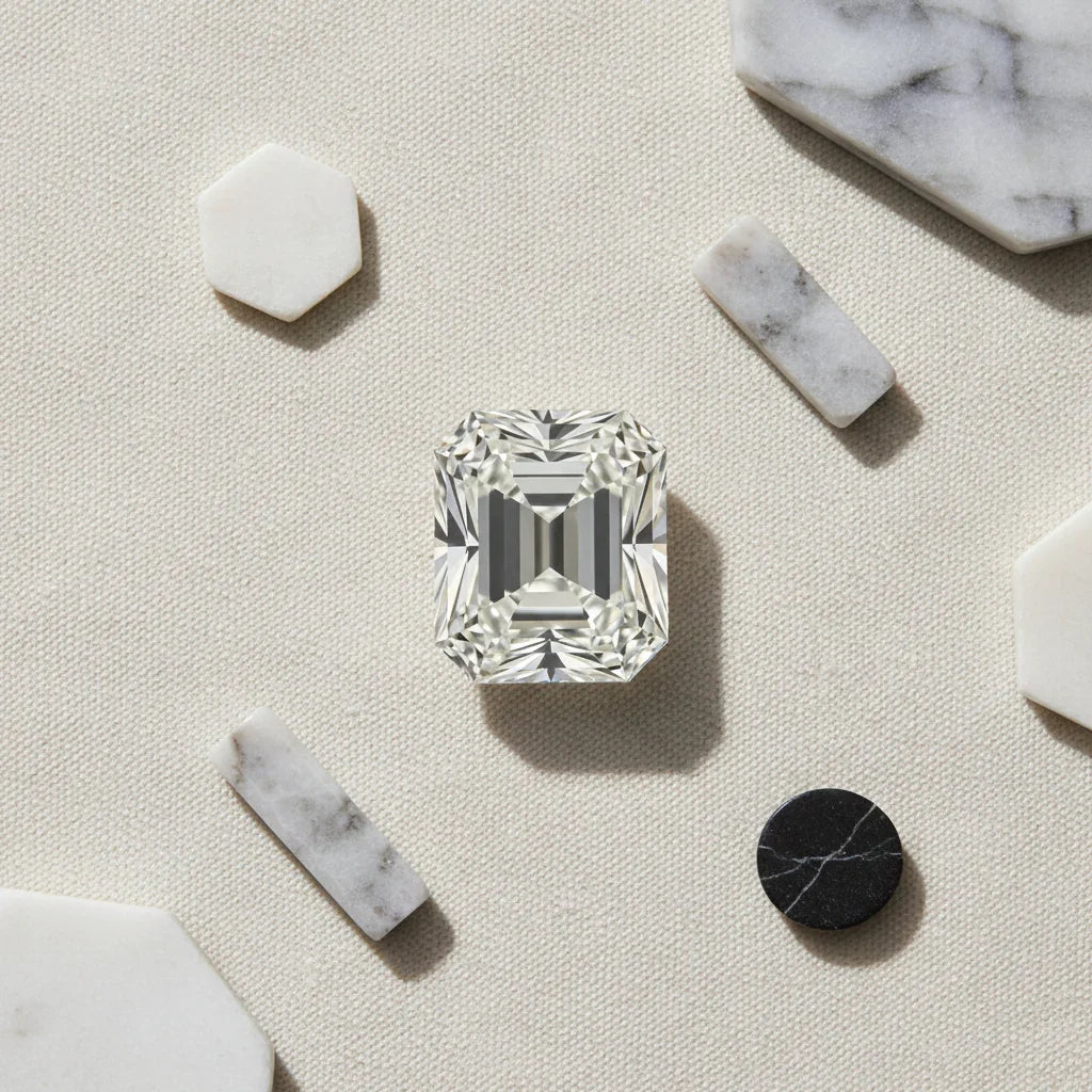 Radiant cut loose diamond on textured surface with marble accents, ideal for bespoke engagement rings