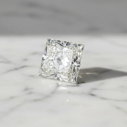 Sparkling princess cut loose diamond on marble surface, ideal for bespoke engagement rings